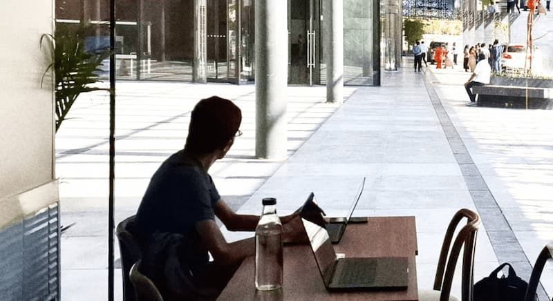 Person working on a laptop at a cafe in Bangalore